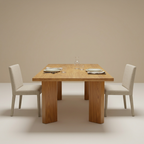 Teak dining table styled with neutral dining chairs and table settings