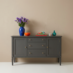 Charcoal sideboard styled with colorful ceramics and flowers