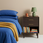 Espresso nightstand beside blue bedding with colorful accessories