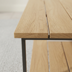 Close-up of slatted wood top and black metal support