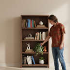 Person selecting a book from the teak bookshelf