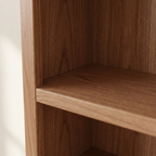 Close-up of warm brown bookshelf grain and shelf edge