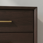 Close-up of espresso nightstand drawer and gold-tone handle