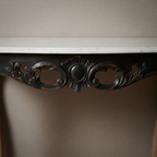 Close-up of decorative console apron carving