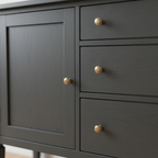 Close-up of charcoal sideboard panel detailing and round knobs